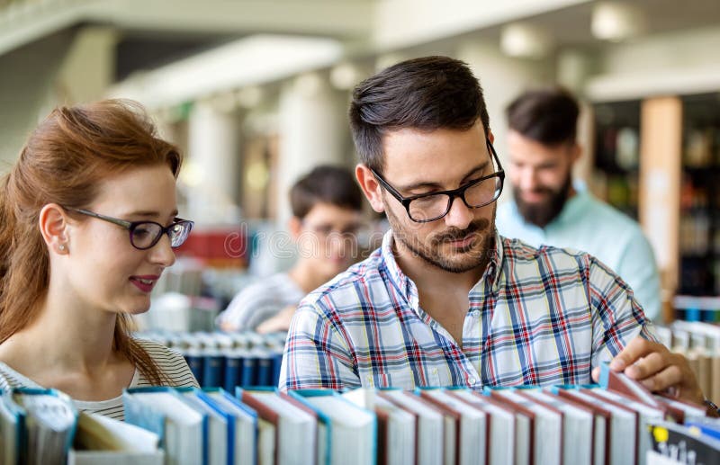 Happy University Students Studying With Books In Library Group Of