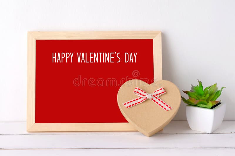 Happy valentine`s day on wood board and heart shape gift box on