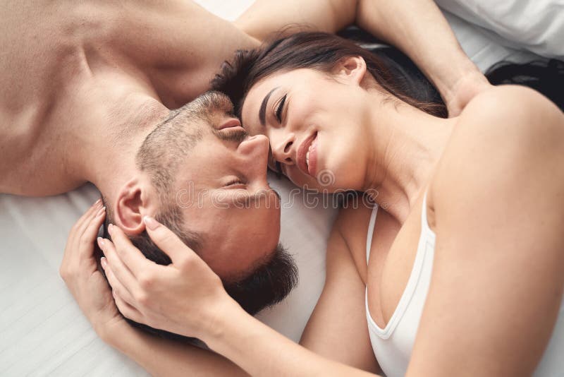 Happy Wife and Her Husband in a Bedroom Stock Photo pic