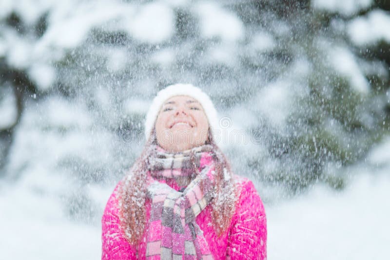 Happy winter women in park snow Christmas lights