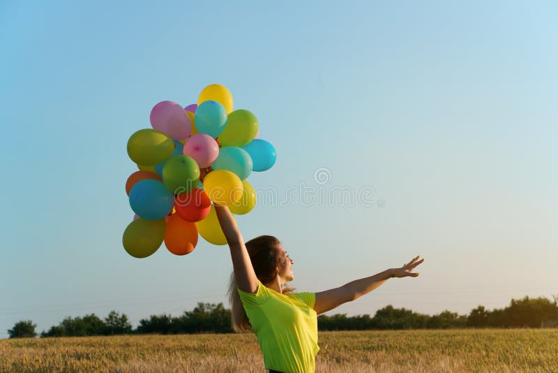 Happy woman with balloons at sunset in summer stock photos Happy woman with balloons at sunset in summer stock photos
