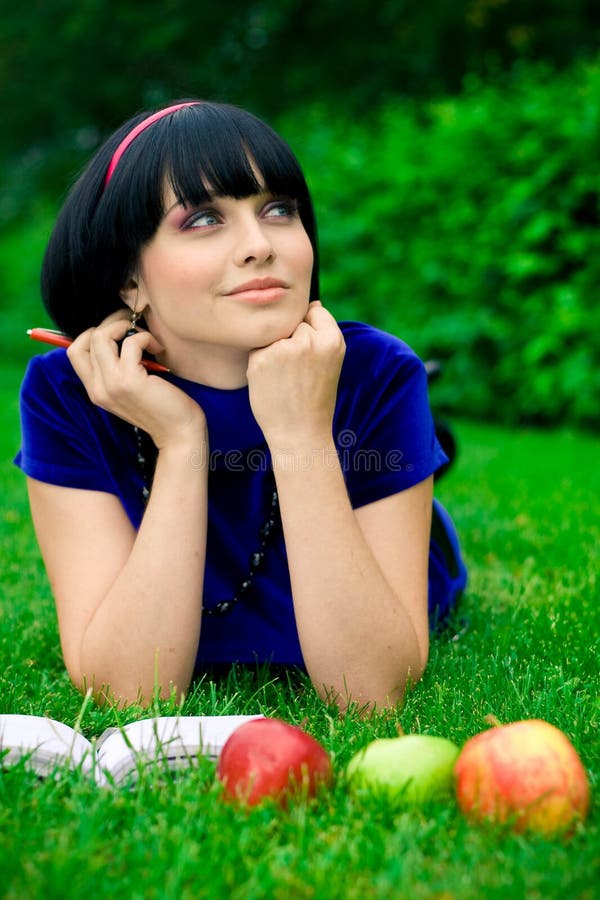 Happy woman with book outdoors