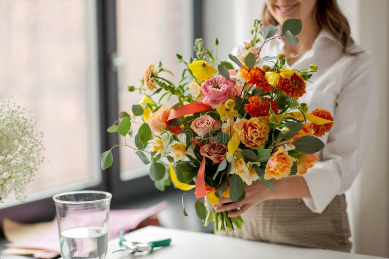 happy woman with bunch of flowers at studio