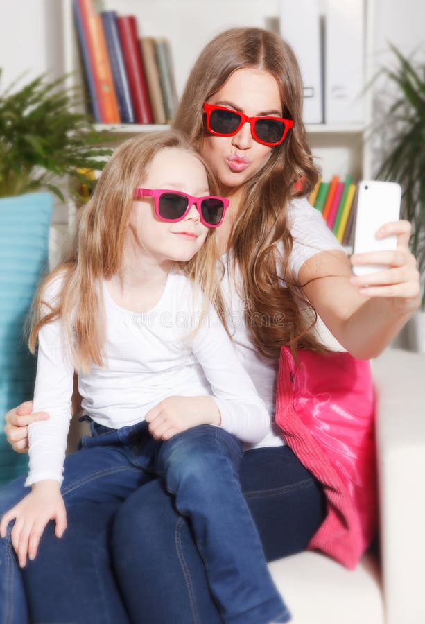 Happy woman and child taking a selfie stock photography Happy woman and child taking a selfie stock photography