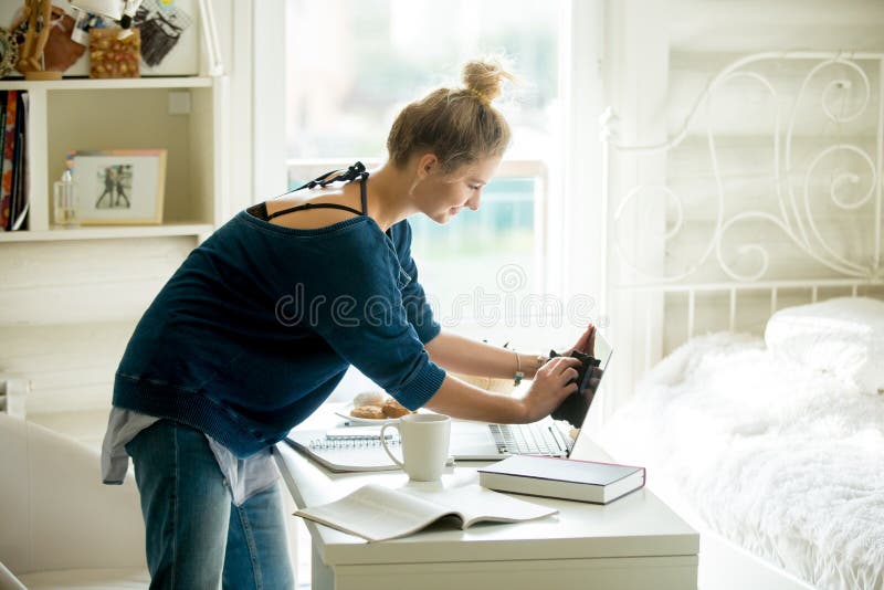 Happy woman cleaning her laptop stock image Happy woman cleaning her laptop stock image