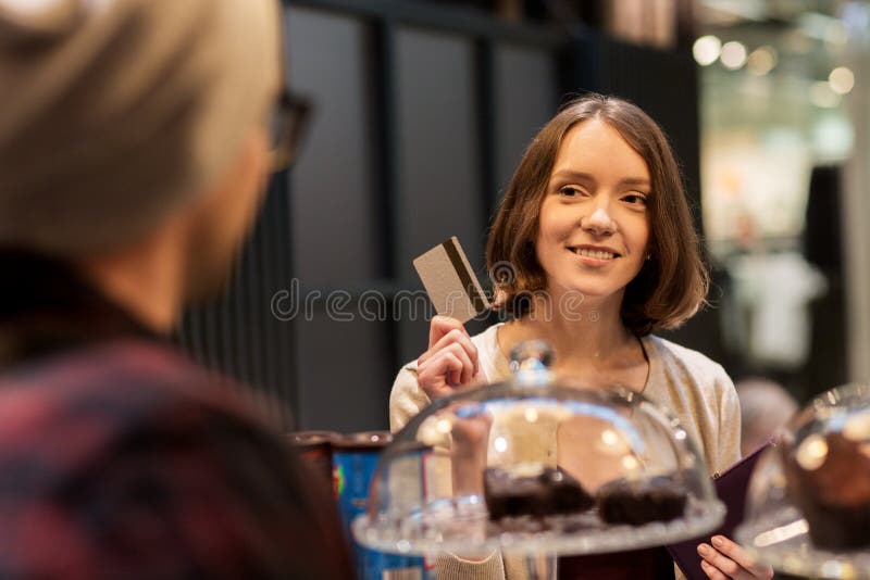 Happy woman with credit card buying cakes at cafe royalty free stock images Happy woman with credit card buying cakes at cafe royalty free stock images