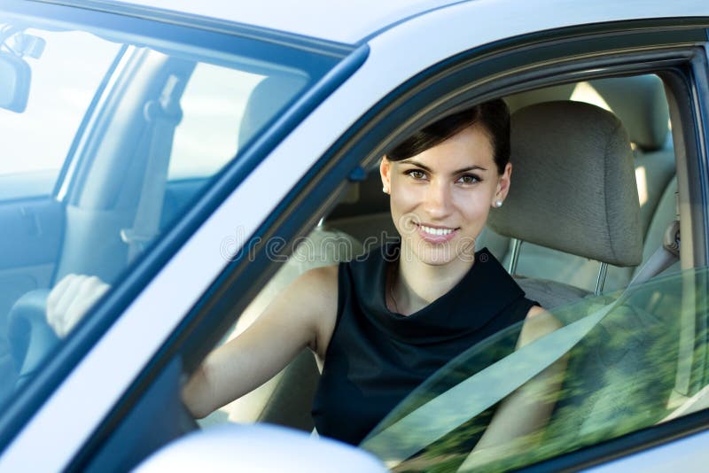 Happy woman driving the car
