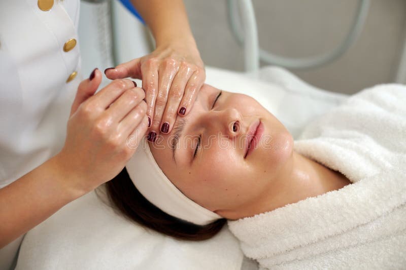 A Happy Woman Enjoying While Cosmetologist Making A Lifting Facial Massage Stock Image Image