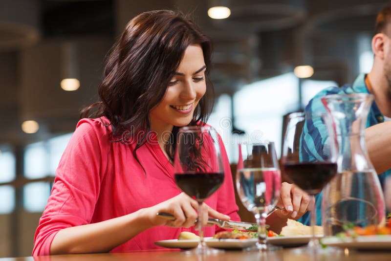 Happy Woman Having Dinner At Restaurant Stock Image - Image of knife