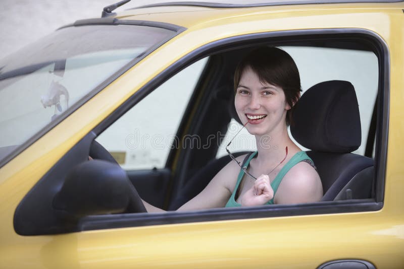 Happy woman in her car with glasses royalty free stock photography Happy woman in her car with glasses royalty free stock photography