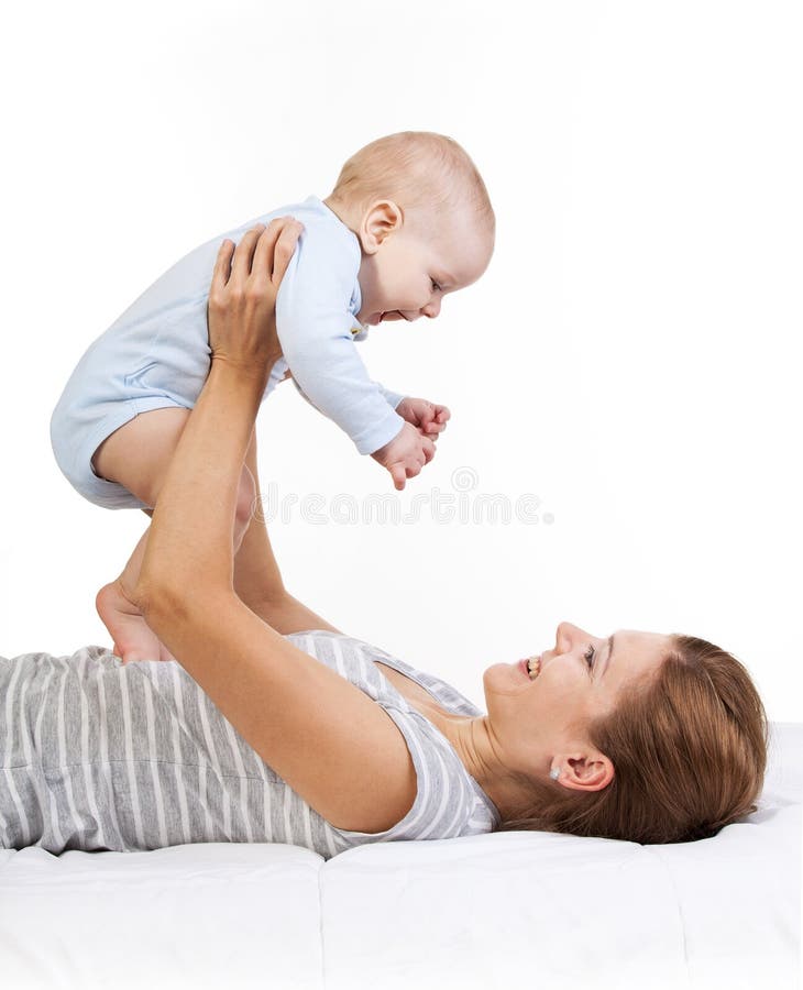 Happy Woman Holding Baby Son while Lying on Back Stock Photo - Image of ...