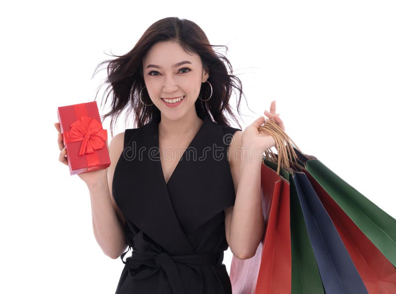 Happy woman holding gift box and shopping bag isolated on a whit royalty free stock image Happy woman holding gift box and shopping bag isolated on a whit royalty free stock image