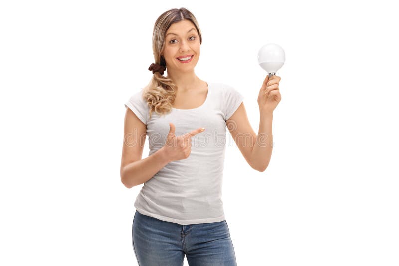 Happy woman holding a LED light bulb and pointing royalty free stock photos