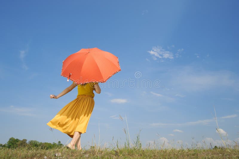 Happy woman holding umbrella and cloud sky