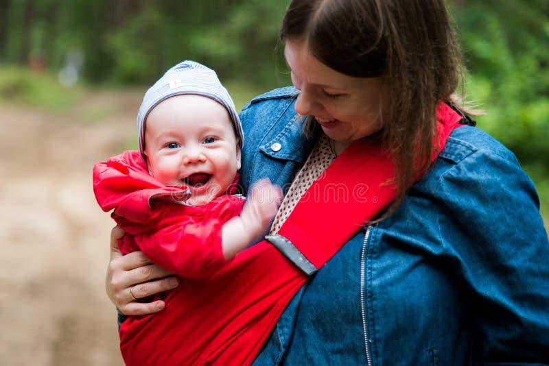 Happy woman with infant baby in forest having fun