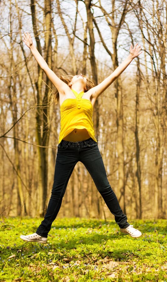 Happy woman jumping in nature