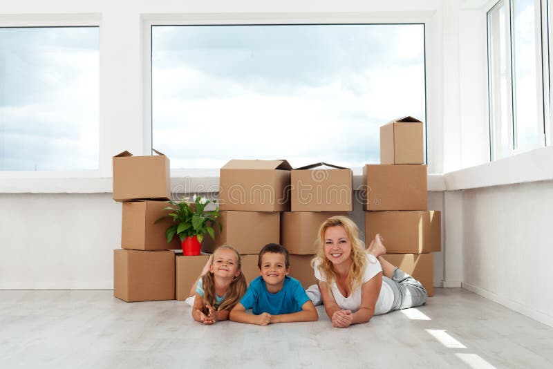 Happy women and kids in their new home - relaxing in fron of large window. Happy women and kids in their new home - relaxing in fron of large window