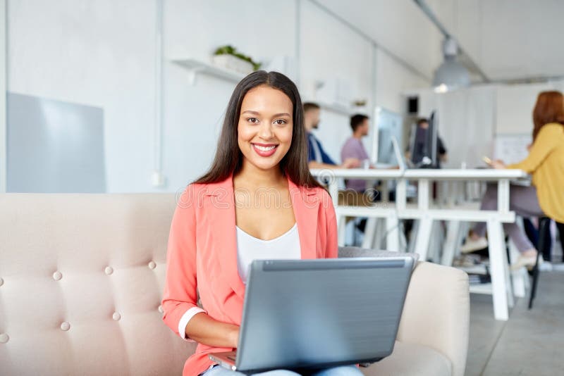 Happy woman with laptop working at office stock images Happy woman with laptop working at office stock images