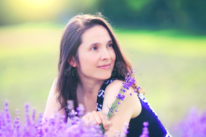 Beauty woman on lavender background. Beautiful girl in meadow fie