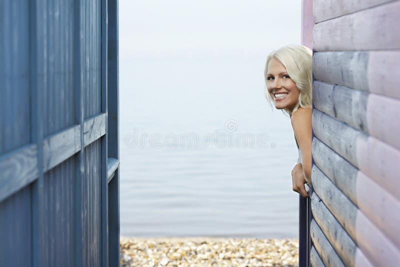 Happy Woman Leaning Out Of Beach House