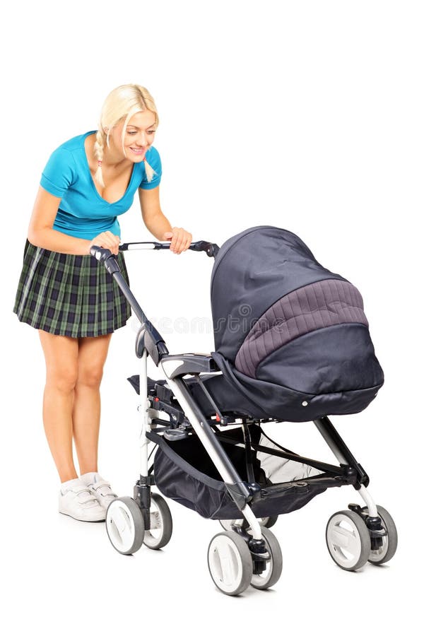 Happy woman looking in a baby stroller stock photography