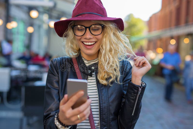 Happy woman looking at her phone