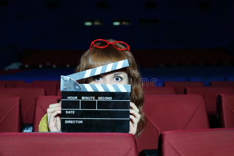 Happy woman looks through clap board