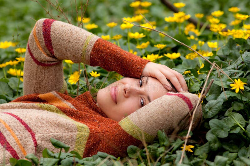 Happy Woman Lying in Field of Flowers