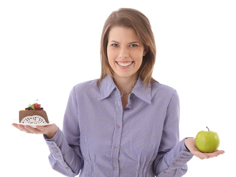 Happy woman offering cake and apple