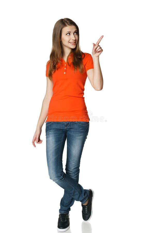 Happy woman pointing to the side standing in full length