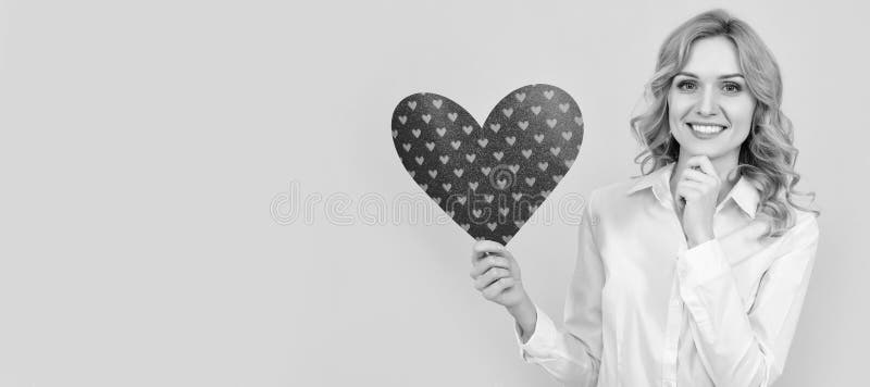 happy woman with red love heart on yellow background. february 14. Woman isolated face portrait, banner with mock up stock images