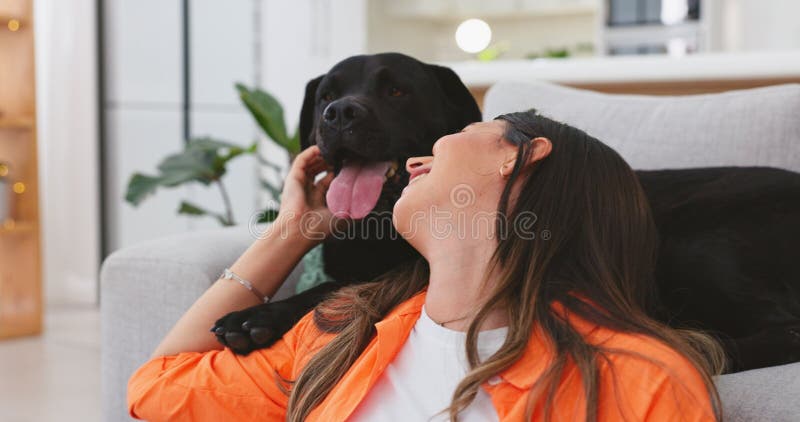 Happy woman relax with her dog at home for mental health, wellness or emotional support, love and care. Young person