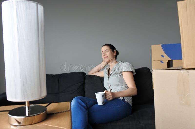 Happy woman relax on a sofa during a move into a new home