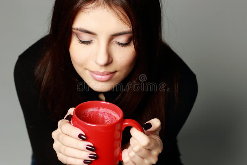 happy woman smelling the aroma of coffee