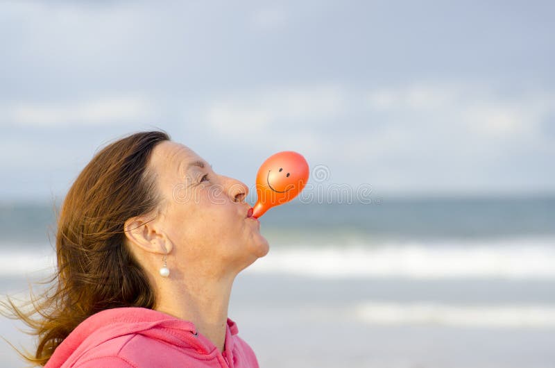 Happy woman with smiley balloon