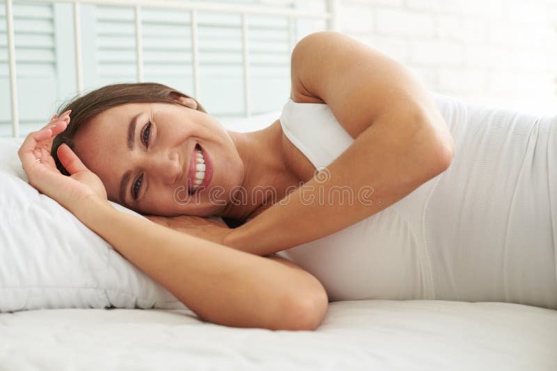 Happy woman smiling brightly after she wakes up