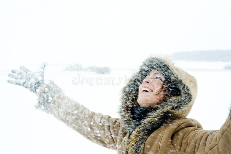 Happy Woman in Snowstorm