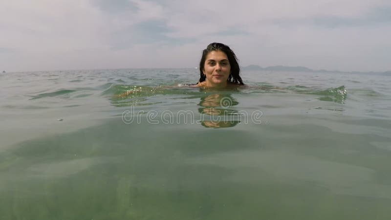 Happy woman swimming in sea water action camera pov of young girl on beautiful beach