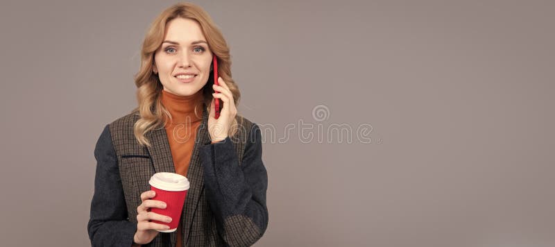 Happy woman talk on mobile phone drinking morning coffee grey background, talker. Woman portrait, isolated header banner stock photos
