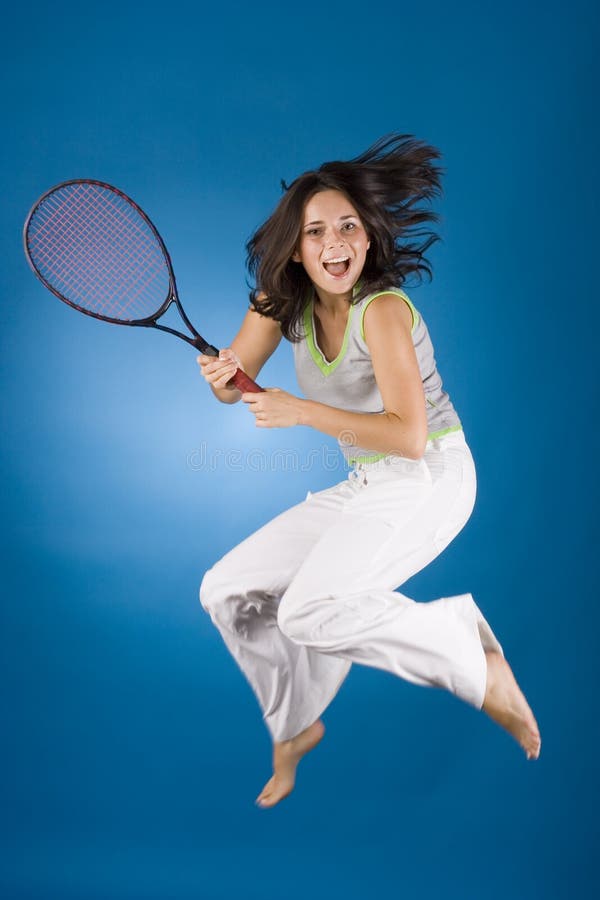 Happy woman with tennis racket on the blue background