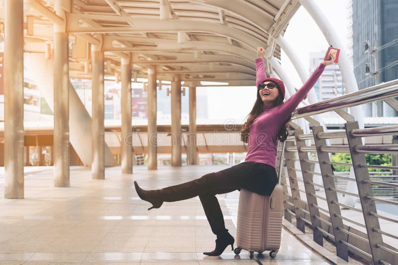 Happy woman traveller at airport walkway