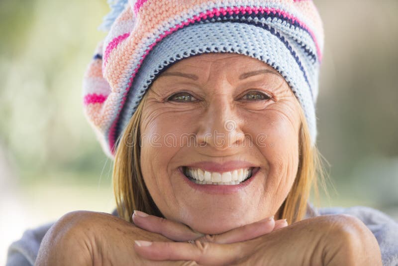 Happy Woman with warm beanie hat in winter outdoor