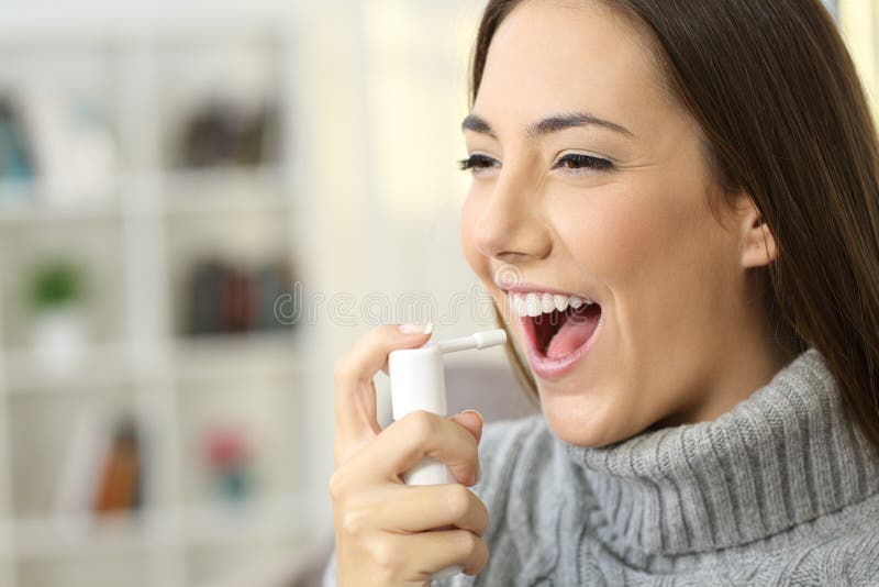 Woman using a analgesic spray