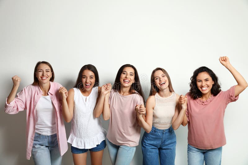 Happy women holding hands on background. Girl power concept