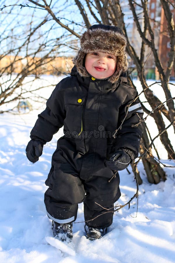 Happy 2 year toddler with rosy cheeks in winter