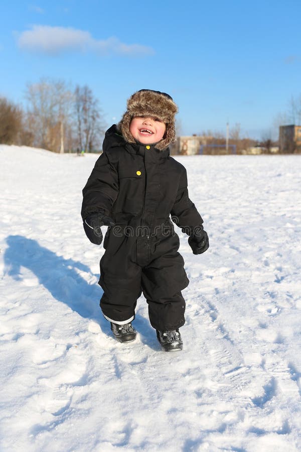 Happy 2 year toddler walking in winter royalty free stock photography