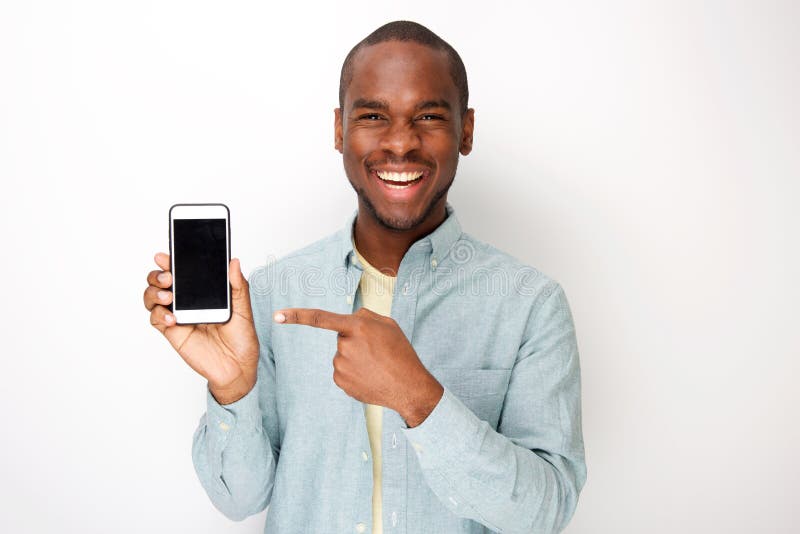 Happy Young African American Man Holding Mobile Phone And Pointing To