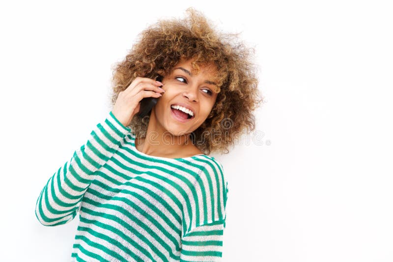 Happy young african american woman talking on cellphone by white background