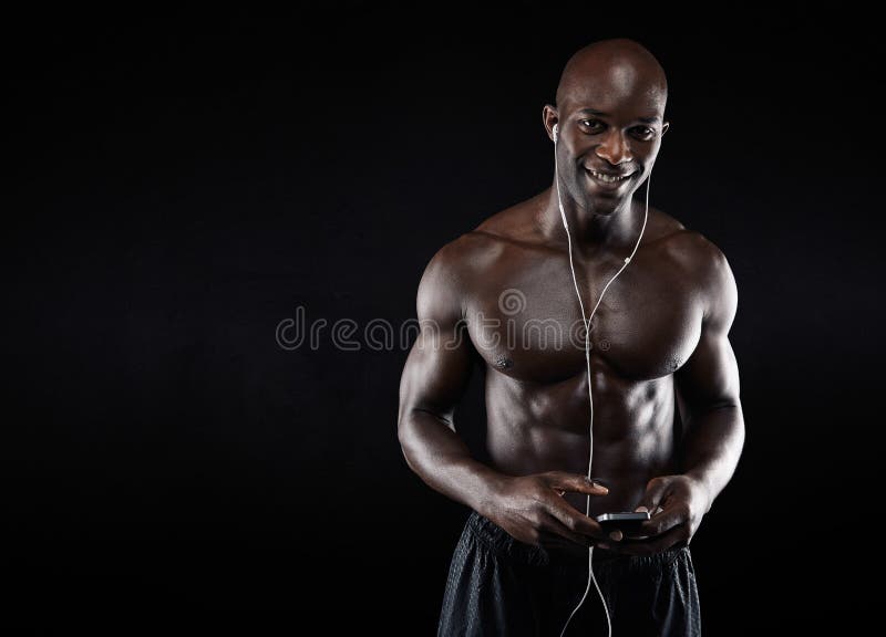 Happy young african man listening to music