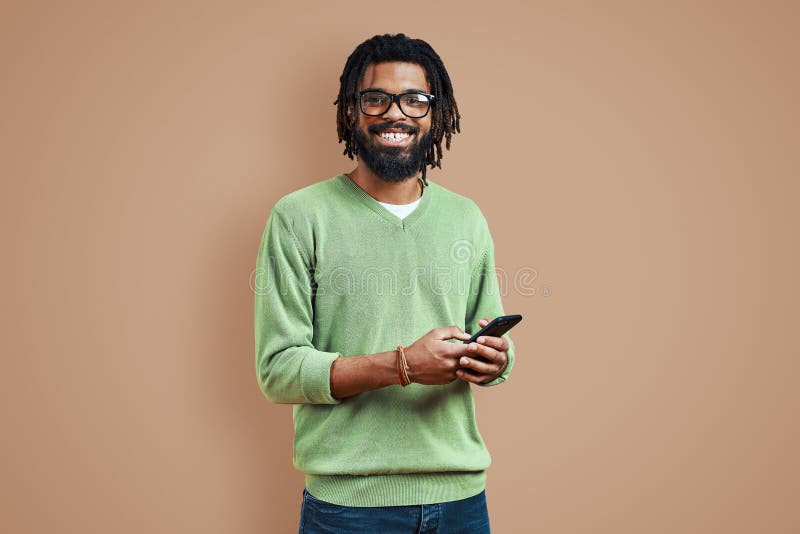 Happy young African man in smart casual clothing